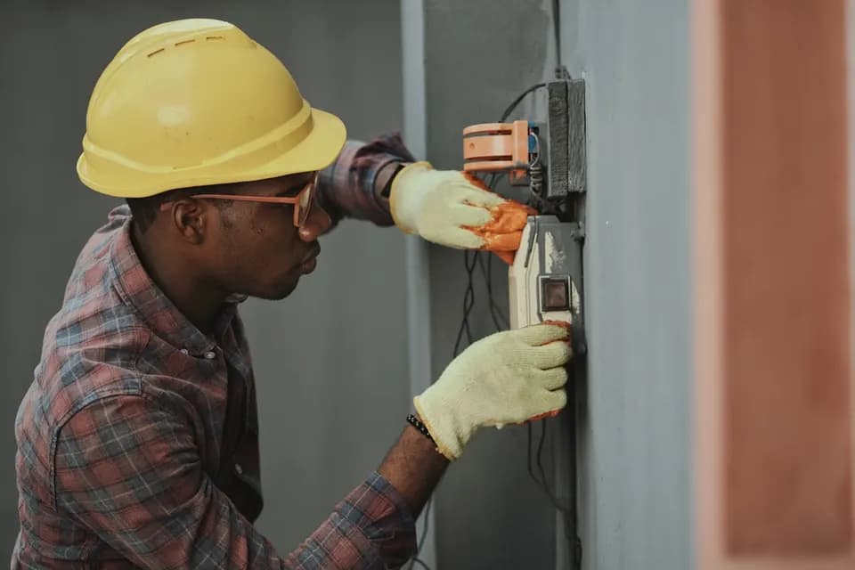Licensed electrician carrying out electrical work in a Deira home